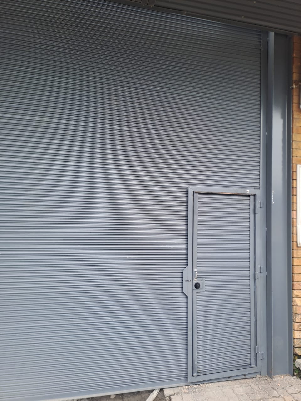 Industrial roller shutter with pedestrian door